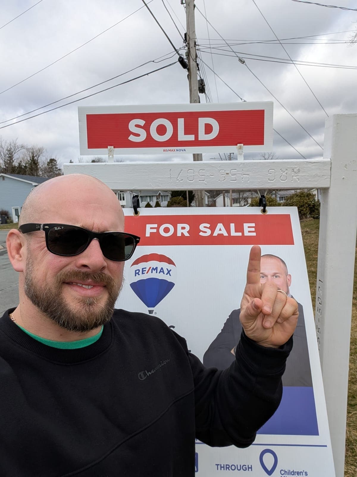 Chris Crowell with a sold sign